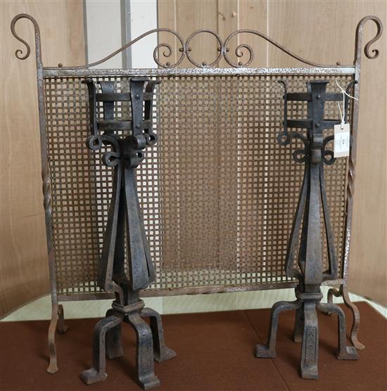 A pair of wrought iron firedogs and firescreen W.85cm